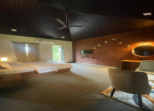 Lawn Facing Room with a direct view of the green lawn at Unwind Karjat